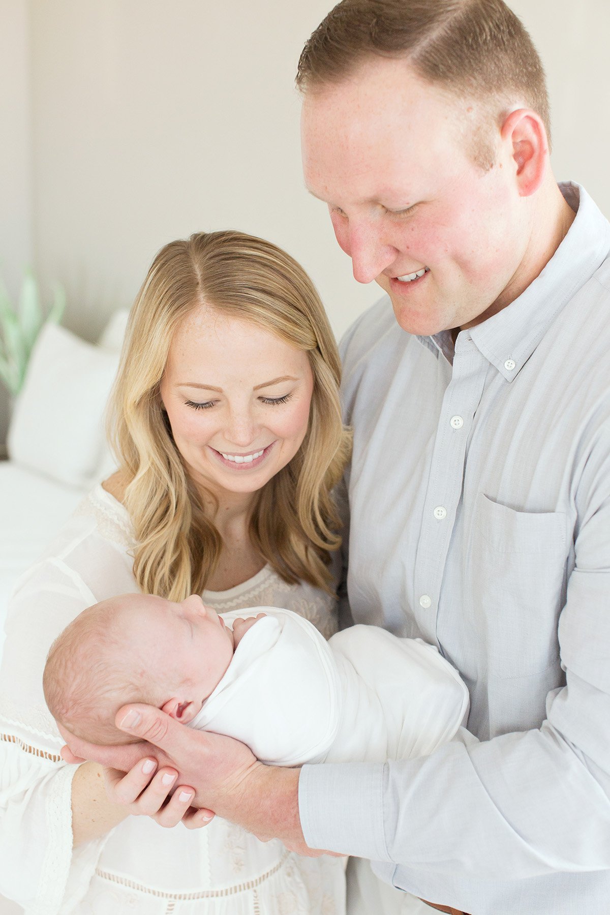 mom and dad hold new baby boy at Julie Brock Photography's studio in Louisville KY