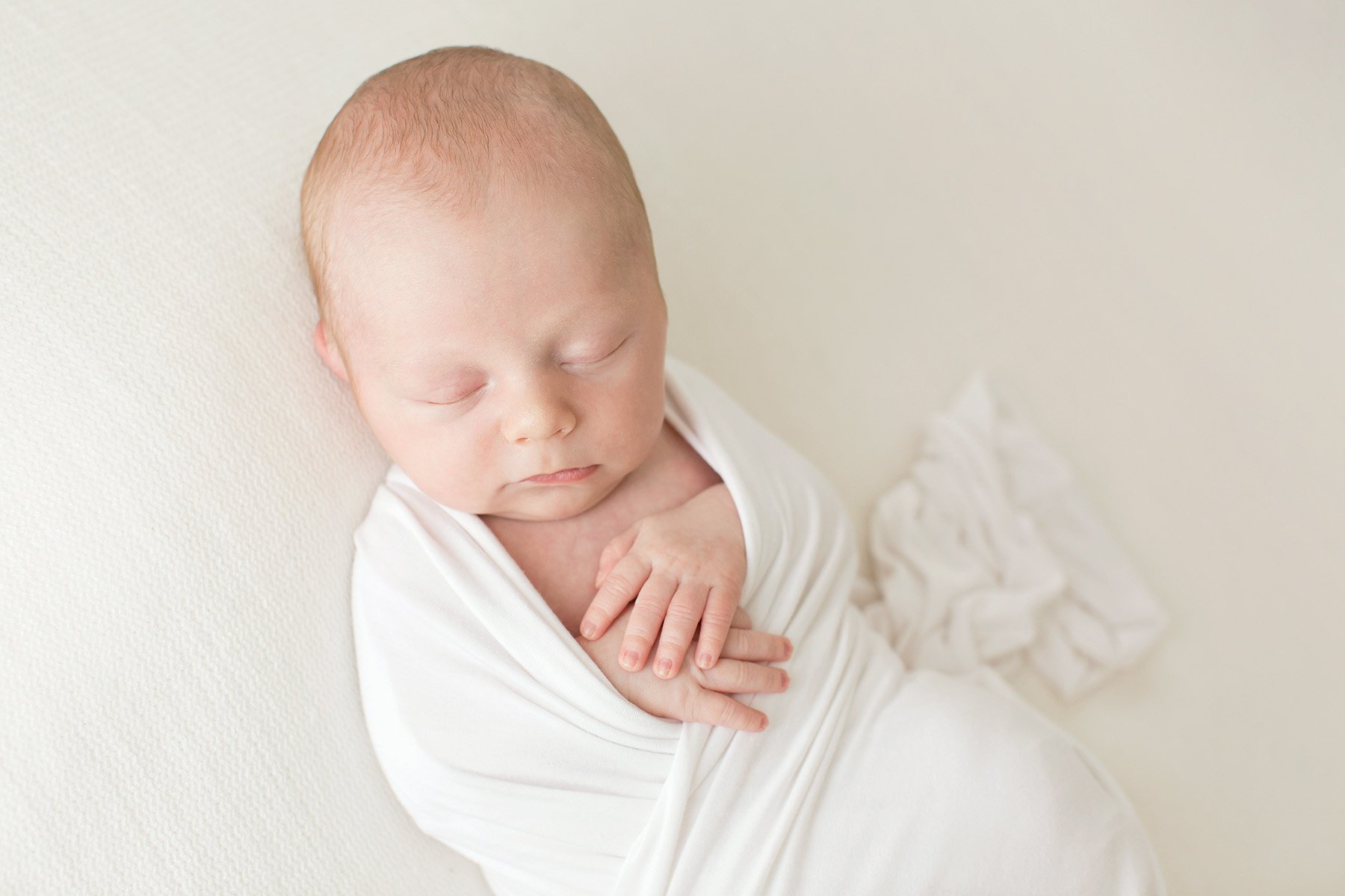 sleeping baby wrapped in white blanket at Julie Brock Photography in Louisville KY