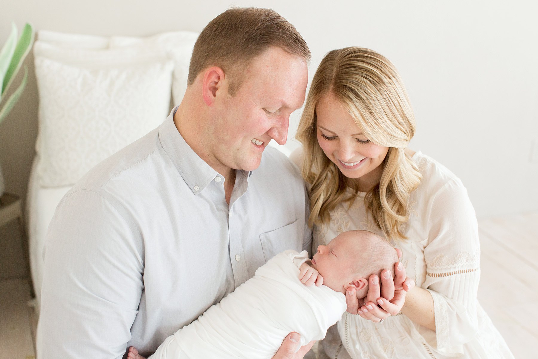 couple smiles at new baby boy in louisville ky with Julie Brock Photography