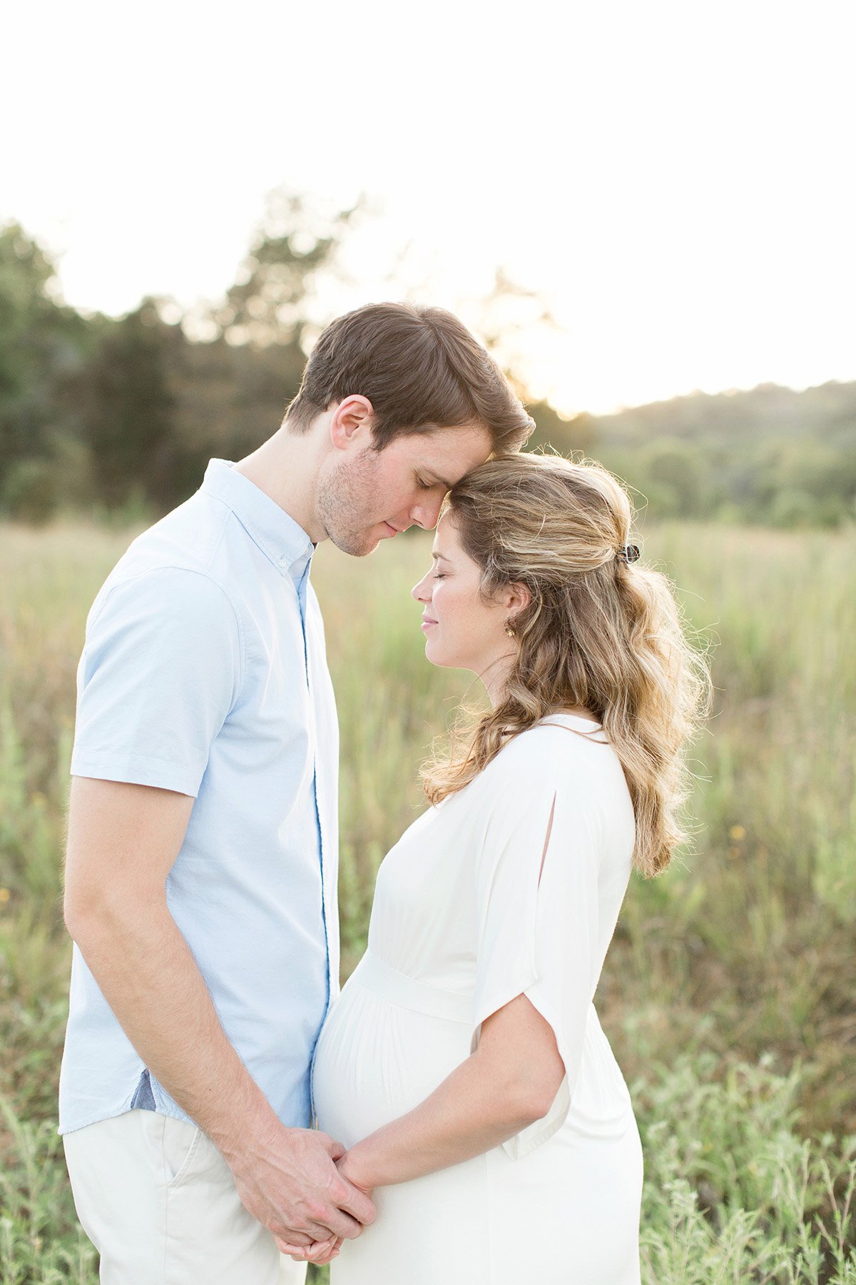 Expectant mother and father in field during maternity photo shoot with Julie Brock Photography in Louisville KY