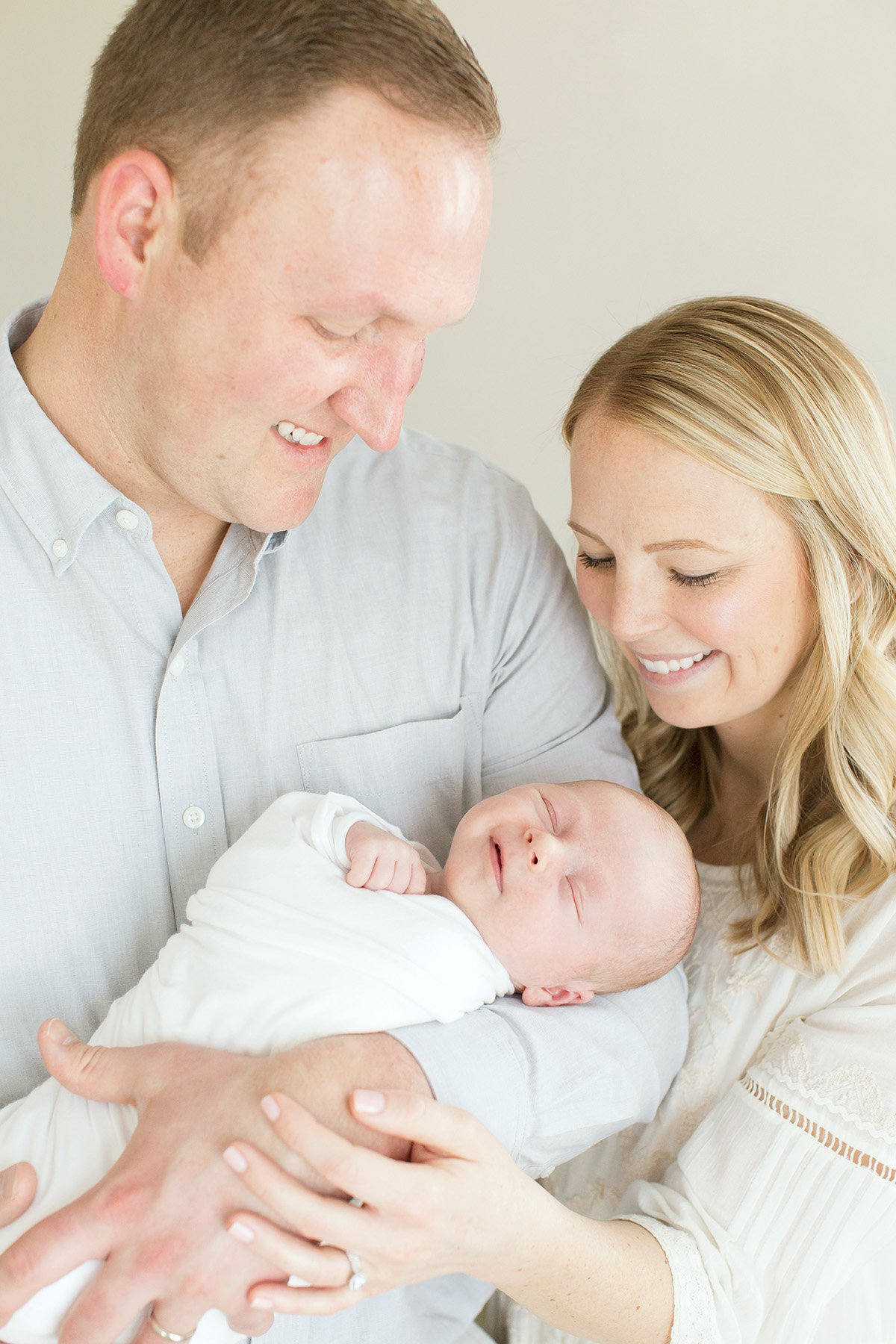Newborn baby boy smiles at parents at Julie Brock Photography in Louisville KY