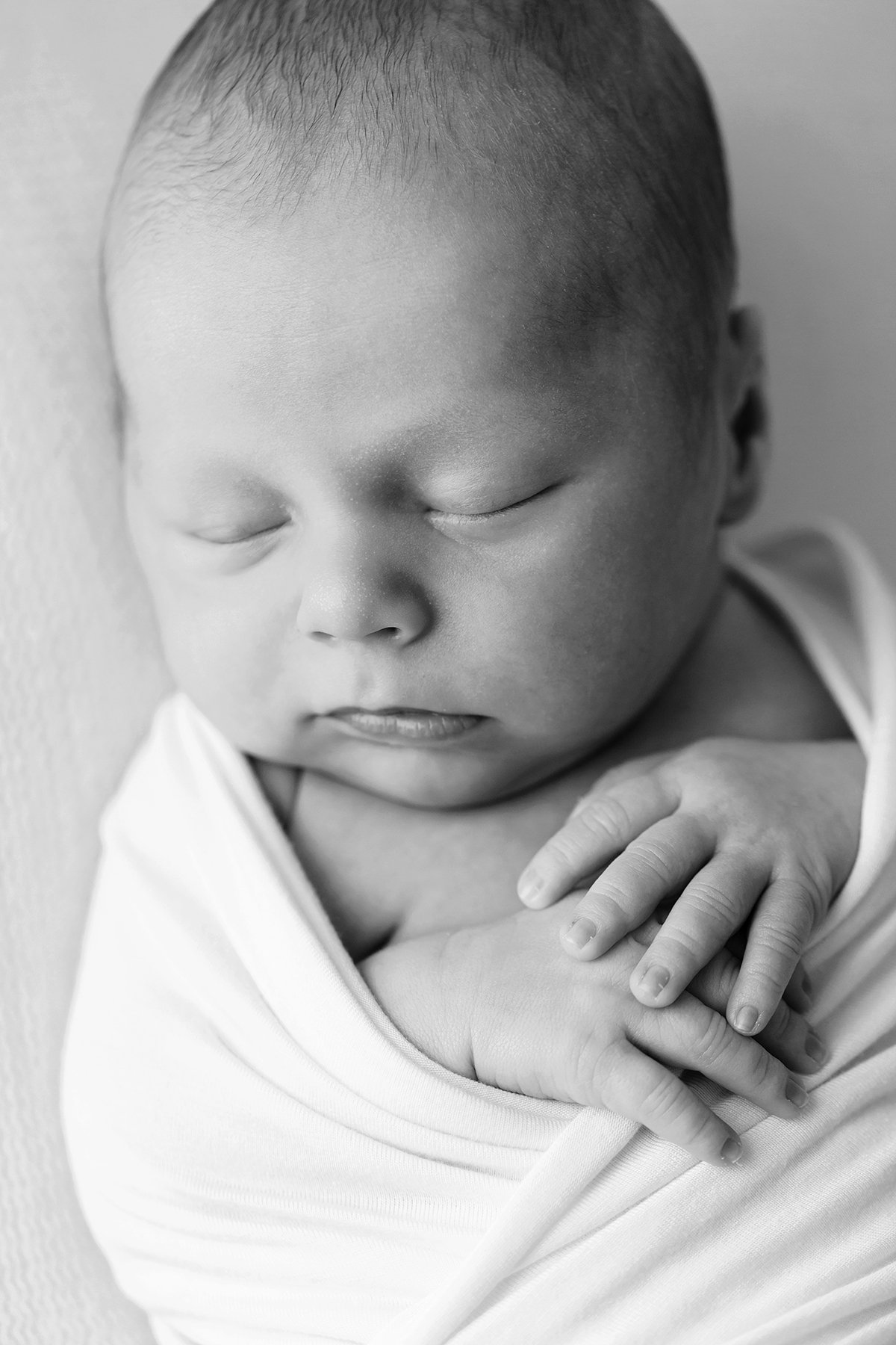 black and white photo of sleeping baby boy