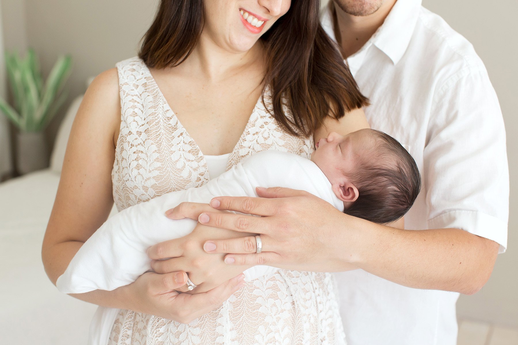 Mom and dad hold their newborn daughter at Julie Brock Photography in Kentucky