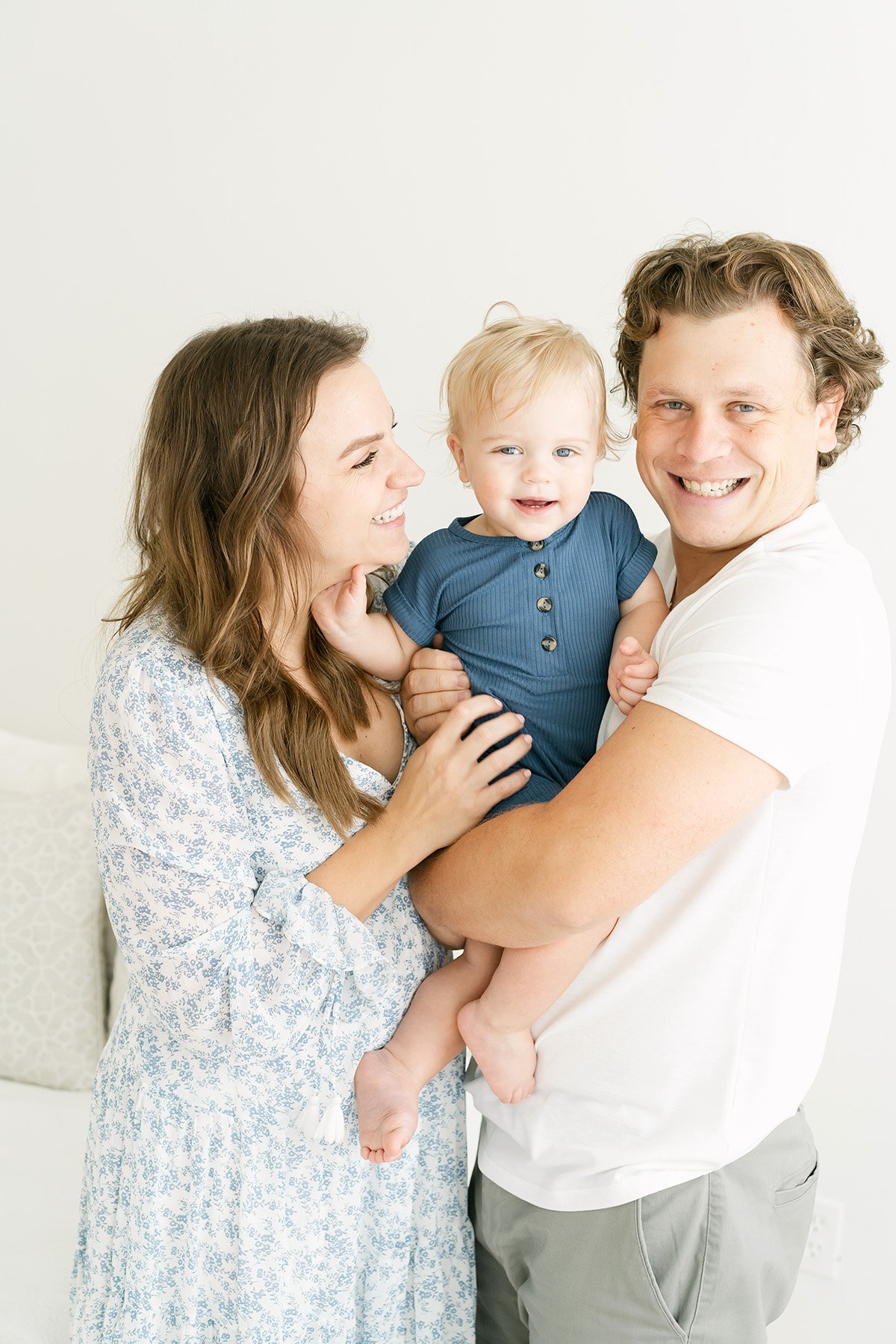Mom and dad laugh with their baby boy during 1st birthday photo session in Louisville KY