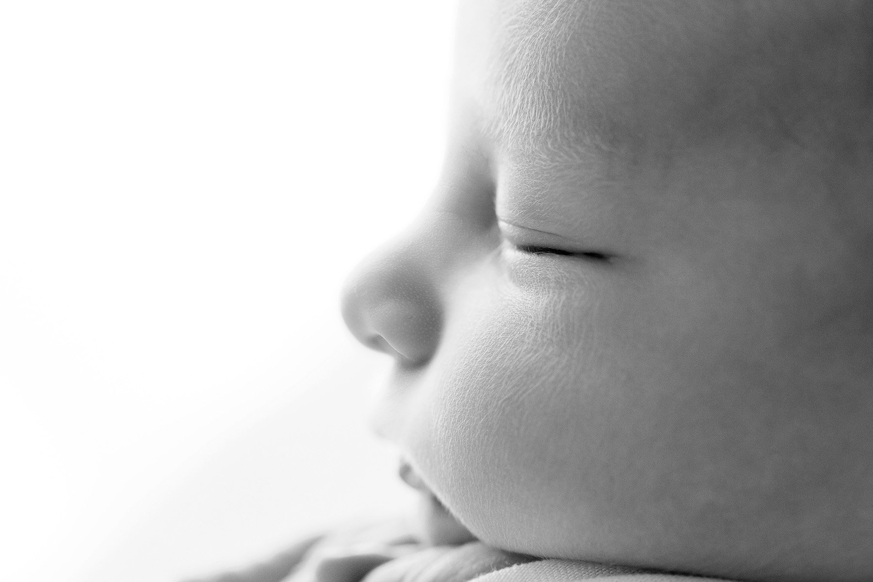 black and white photograph of newborn baby boy profile