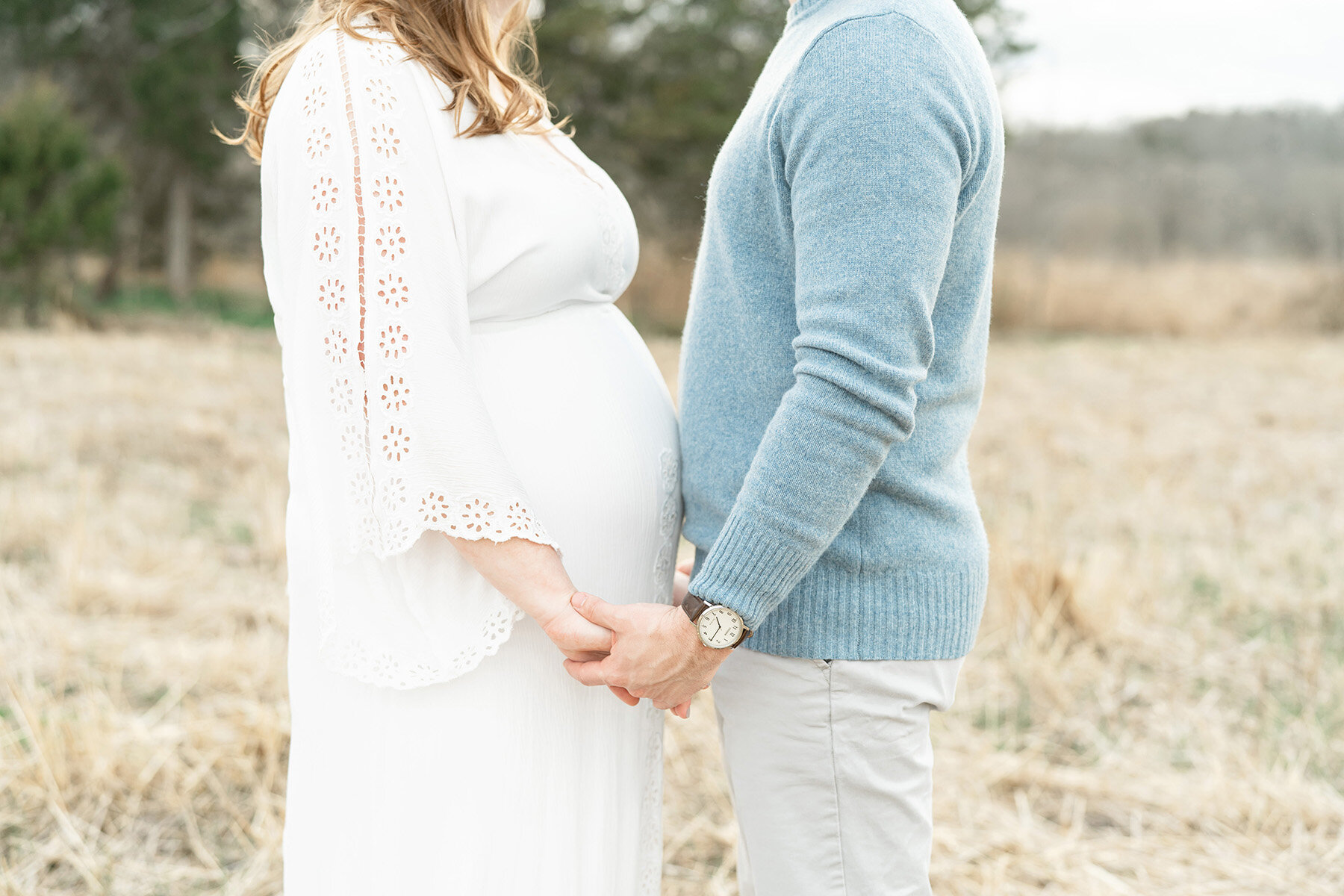 Expectant mother wears Fillyboo dress and holds her husband’s hands at this perfect outdoor location for maternity photos in Louisville KY