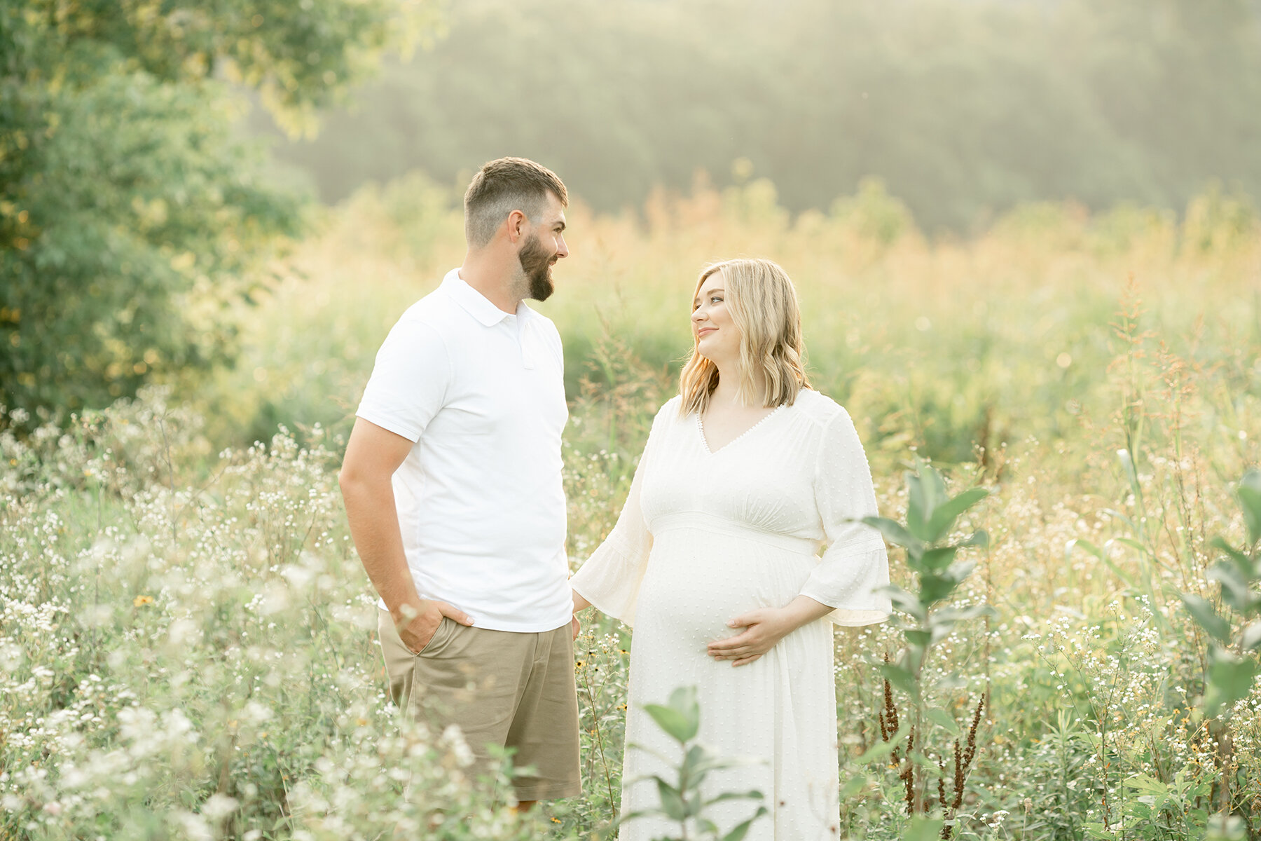 Outdoor maternity photo shoot in field with flowers. Light and airy Louisville KY photographer. Julie Brock Photography