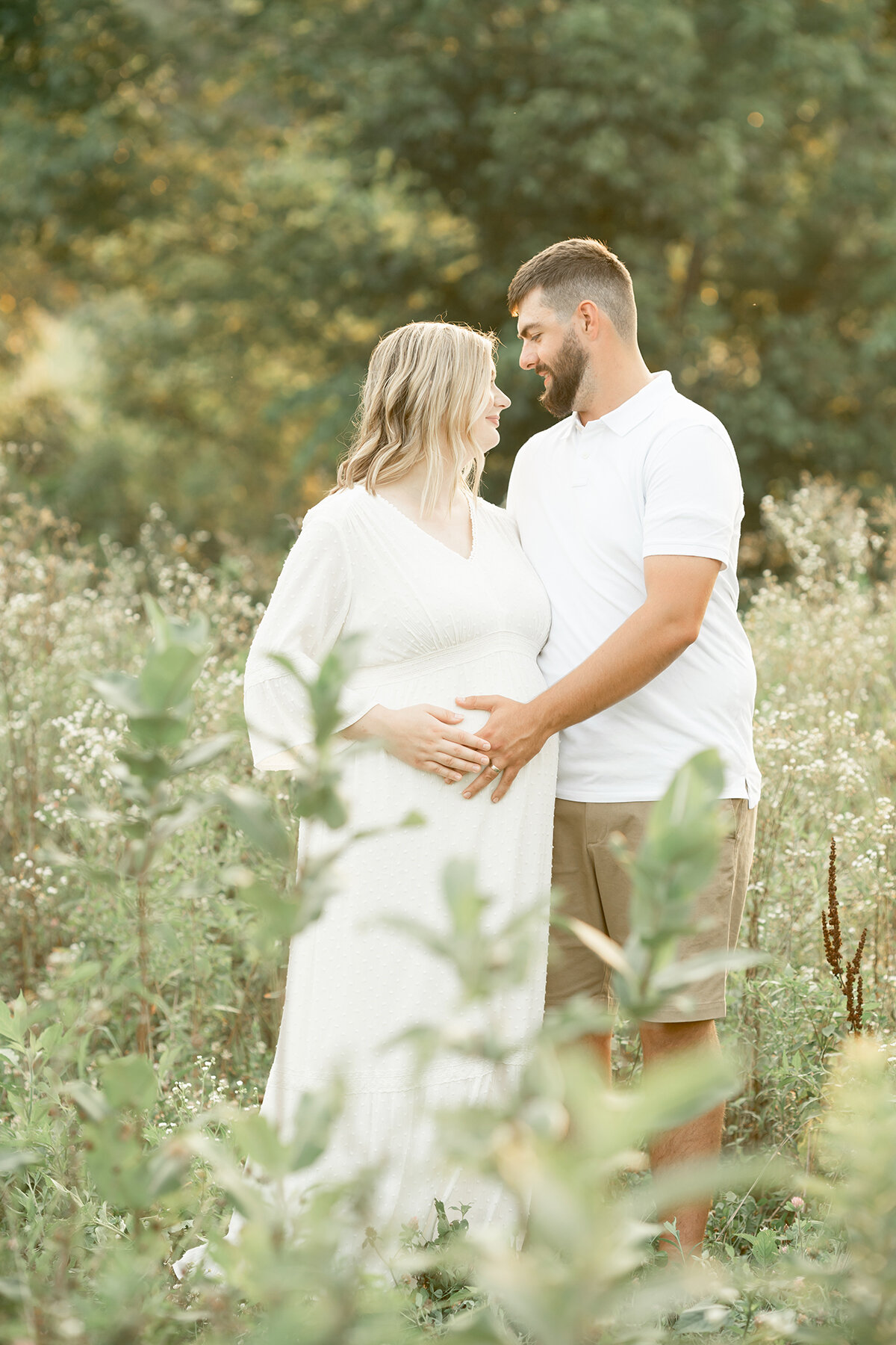 Louisville KY parents expecting baby boy pose in Louisville KY field during outdoor maternity photoshoot with Julie Brock Photography