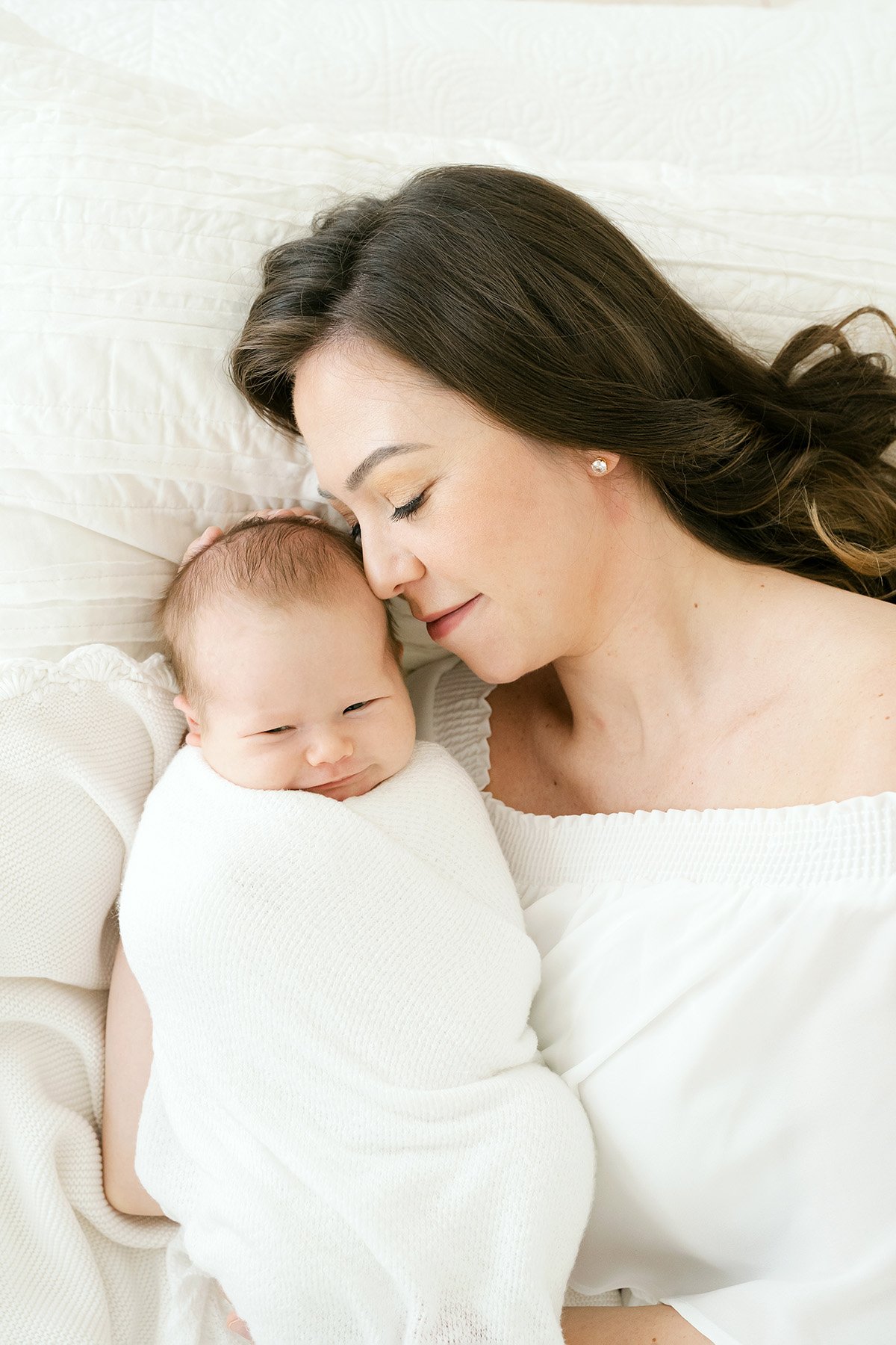Mom snuggles with her sleeping newborn baby during their Louisville KY newborn photo shoot