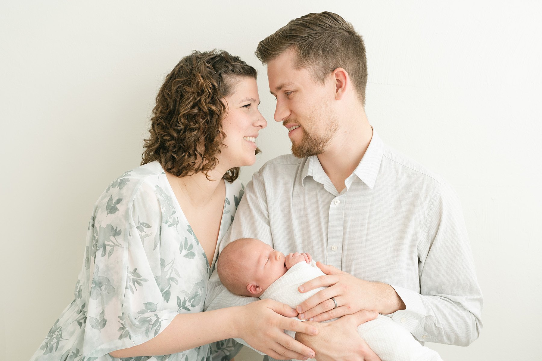 Happy parents hold baby at Julie Brock Photography Studio in Louisville KY