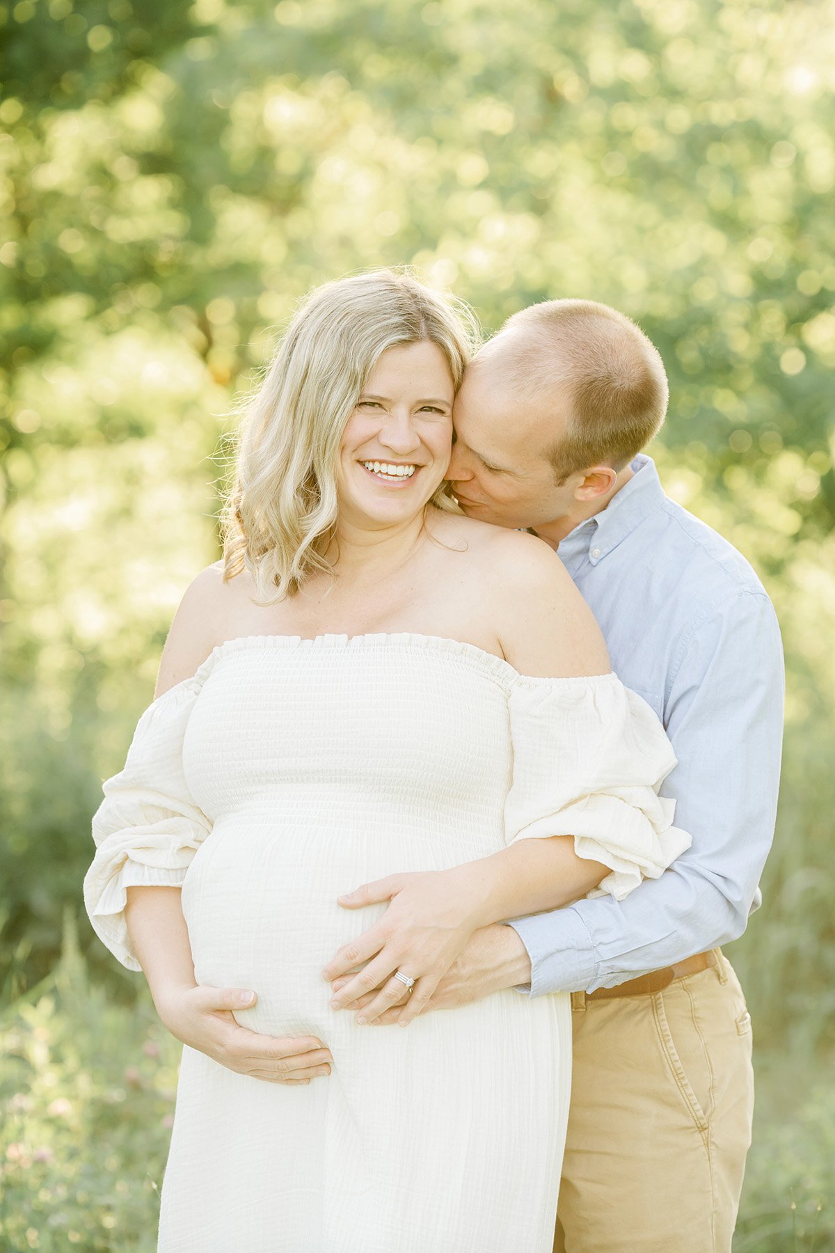 Husband and wife laugh during outdoor maternity photo session with Julie Brock Photography in Louisville KY