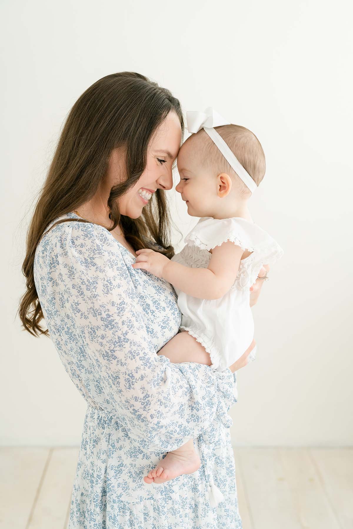 Mother and one year old baby girl smile at each other  at Julie Brock Photography in Louisville KY