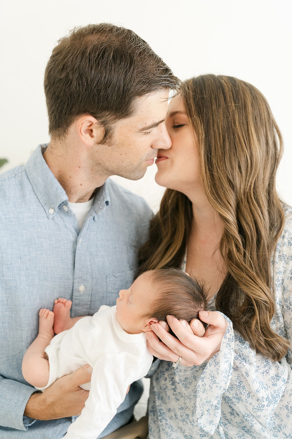 Mom and dad hold baby during newborn photo shoot at Julie Brock Photography in Louisville KY