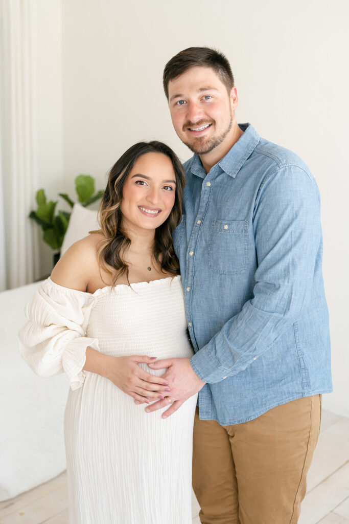 Happy couple smiles during their maternity photo shoot at Julie Brock Photography in Louisville KY