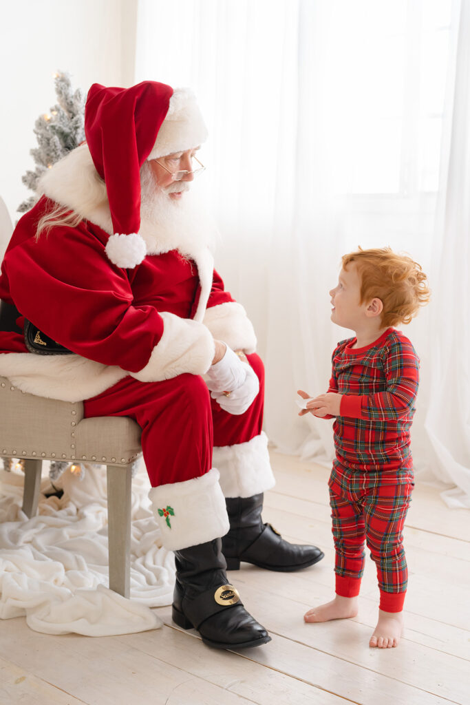 candid-moment-with-little-boy-talking-to-santa-in-louisville-ky-with-julie-brock-photography