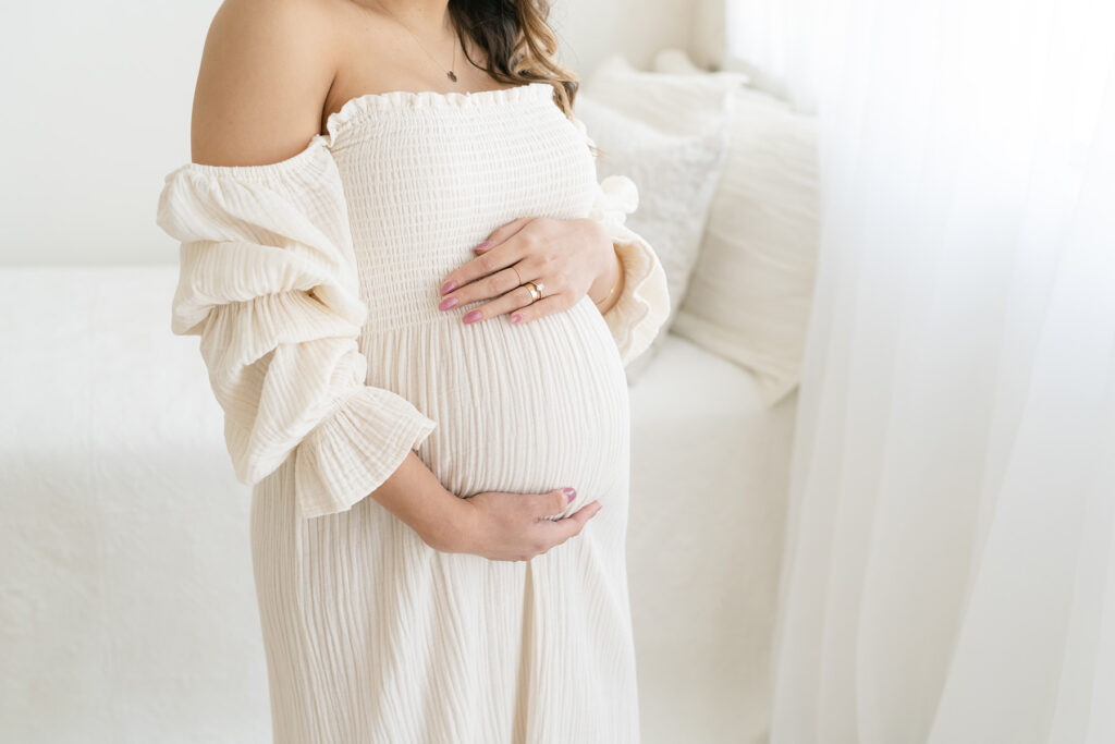 Mother wears off shoulder dress from Julie Brock Photography's wardrobe during her maternity pictures in Louisville KY
