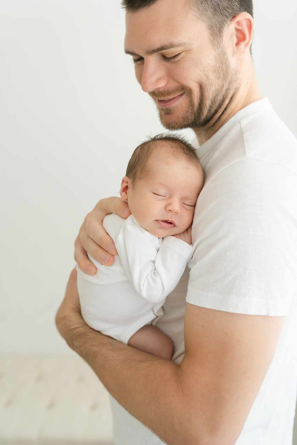 Louisville KY newborn baby and his dad smile during candid moment at Julie Brock Photography