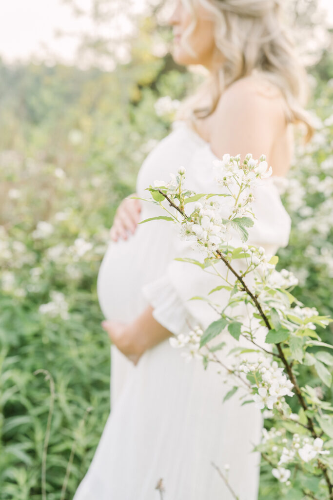 Pregnant mother wears off shoulder dress from Julie Brock Photography for her outdoor maternity photo shoot in Louisville KY