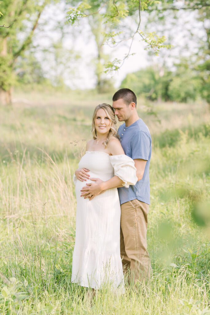 Expecting parents pose for maternity portraits at local park in Louisville Ky with Julie Brock Photography