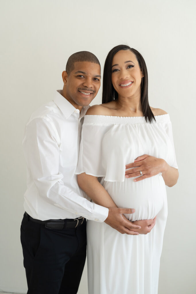 Husband and wife pose for traditional portrait during maternity pictures in Louisville KY