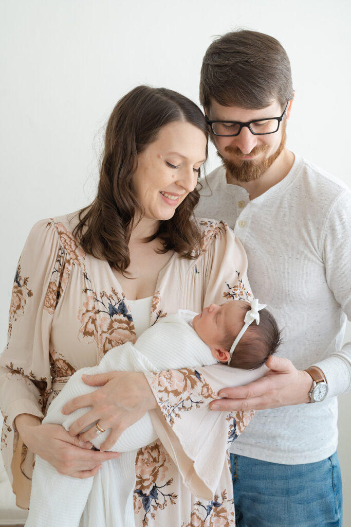 New Louisville KY parents smile at their baby during photos at Julie Brock Photography