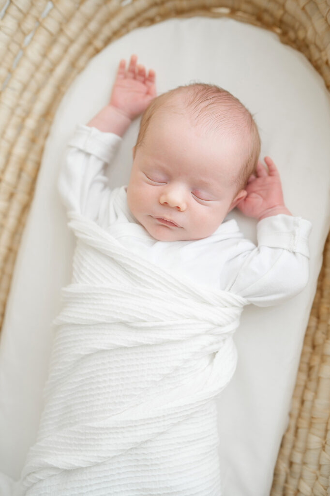 Louisville KY baby stretches while sleeping during newborn photo session with Julie Brock