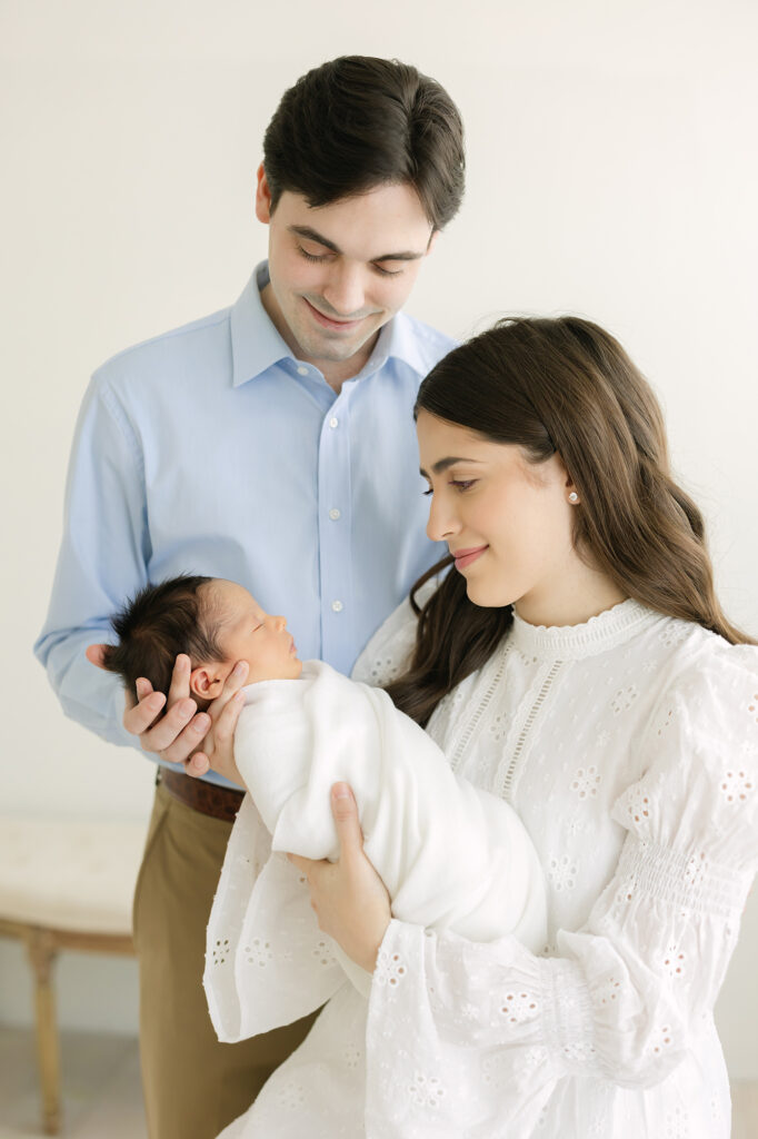 Louisville Newborn Photographer Julie Brock poses parents while they hold they newborn baby boy