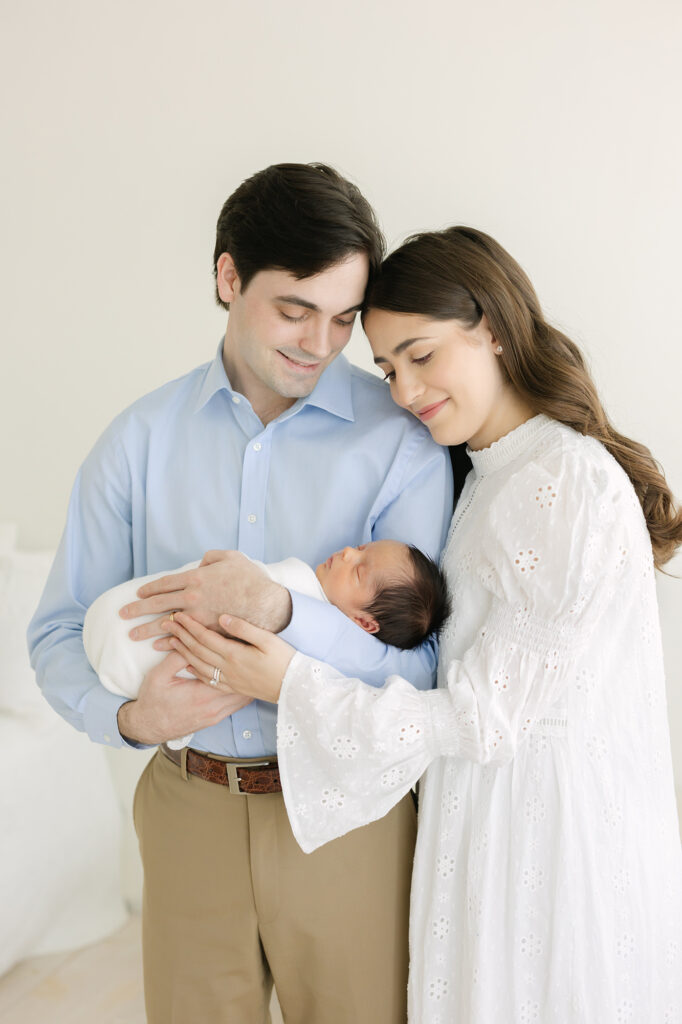 Louisville Newborn Photographer Julie Brock poses parents while they hold they newborn baby boy