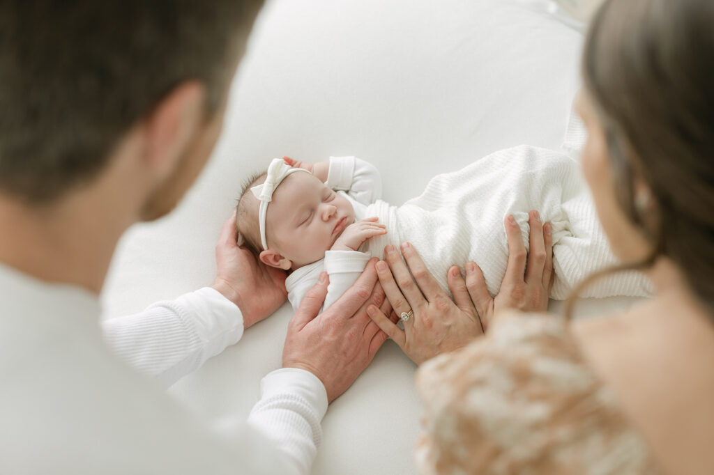 Louisville family photographer Julie Brock poses parents for image of parents and baby girl