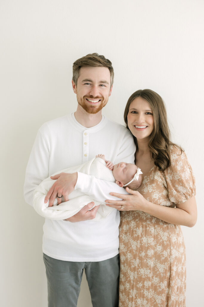 Louisville parents hold baby girl for family photographer Julie Brock