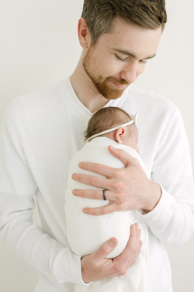 Louisville father holds baby girl for newborn photography with Julie Brock