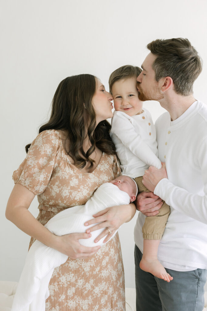 Candid image of Louisville parents hugging their children at Julie Brock Photography Studio