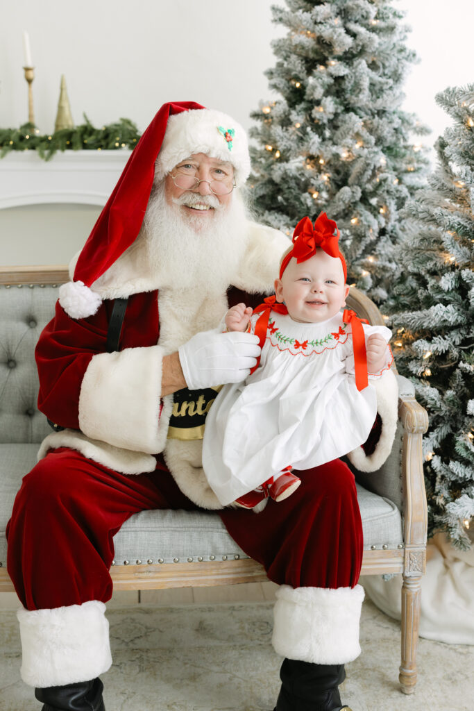 Baby girl smiles at pictures with Santa event in Louisville KY