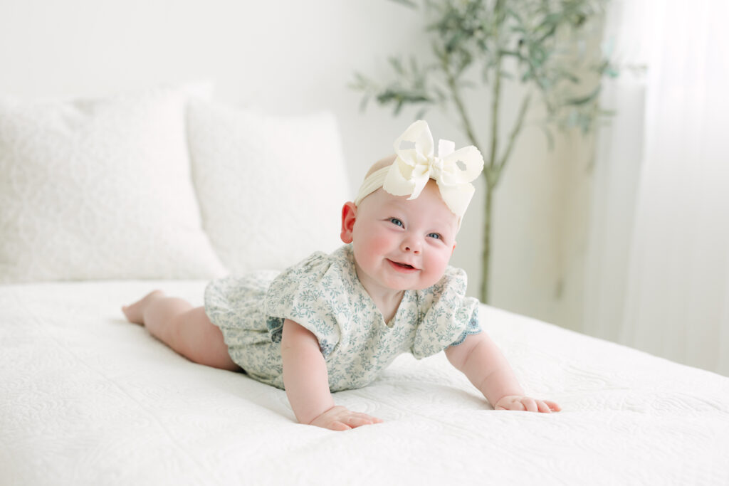 6 month old baby lays on her belly during family photo session at Julie Brock Photography in louisville ky
