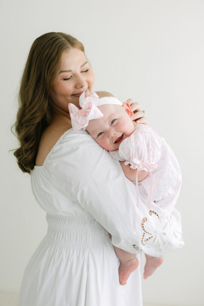 Louisville mother snuggles with her 6 month old baby at Julie Brock Photography Studio