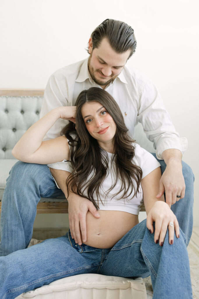 Pregnant mother smiles in a relaxed, modern maternity session in Louisville KY photography studio with Julie Brock Photography