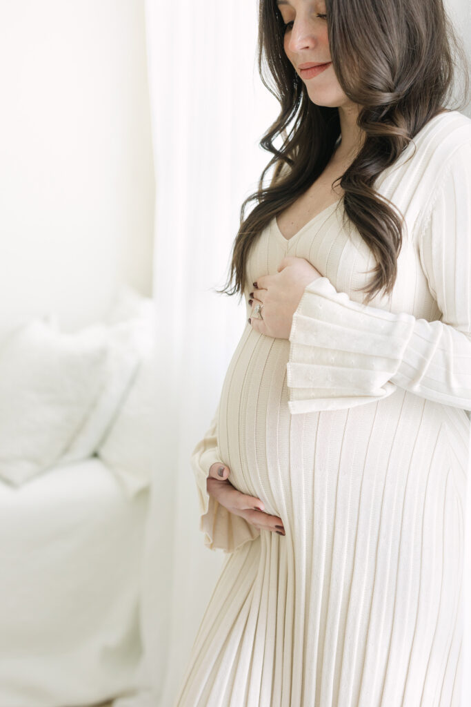 soon-to-be-mother wears fitted sweater dress from Julie Brock Photography's studio clothing line during her Family Photo Session Maternity Photo Session in Louisville KY