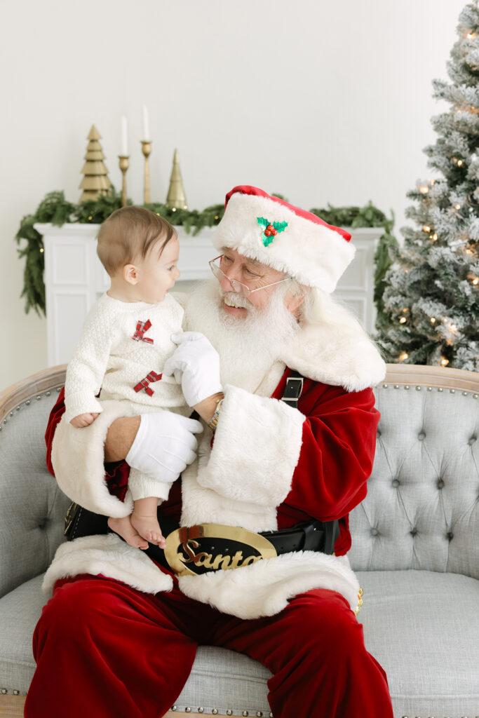 baby girl smiles at Santa during Louisville Ky photos with Santa event at with photographer Julie Brock