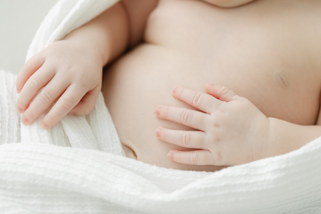 Up close detail photo of newborn baby's hands taken at light-filled newborn studio near louisville ky